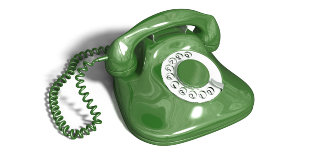 Ein grünes Telefon mit Wählscheibe
